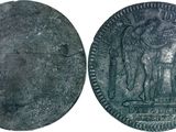 a close up of a coin with an image of a man holding a sword