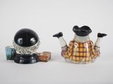 two salt and pepper shakers sitting next to each other