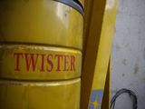 a yellow trash can with the word twister written on it