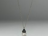 a diamond and sapphire pendant on a silver chain