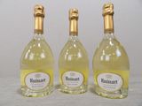three bottles of wine sitting next to each other on a table