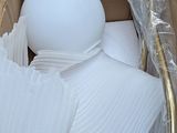 a cardboard box with a white ball inside of it
