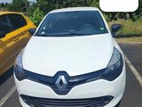 a white car parked in a parking lot next to a yellow car
