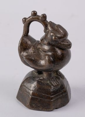 figurine en bronze représentant un oiseau sur un socle, sur fond blanc