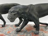 statue of a dog and a cat on a marble base