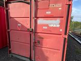 two red containers sitting next to each other on the train tracks