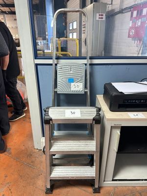 a ladder that is next to a printer on a table