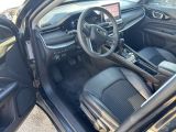 the interior of a car with the door open showing the steering wheel and dashboard