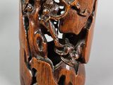 an image of a wooden cup with a carved design of a man and a dog