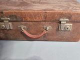 an old suitcase sitting on a table on a table