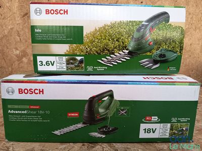 two bosch hedge trimers are sitting on a table in front of a cardboard box