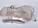 four pieces of silver metal on a white surface