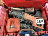 a red tool box with tools in it and a person standing next to it