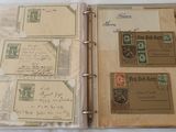 an open book with stamps on it sitting on a table