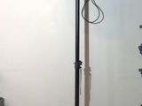 a speaker that is sitting on a tripod in a room