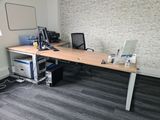 a desk with two computers and a monitor on it