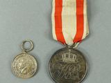 an image of a medal and a coin on a table