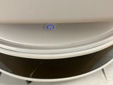 a laptop sitting on top of a stack of plates
