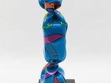 a blue sculpture of a woman with a hat on her head