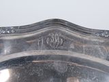 a silver tray with a silver handle on a table