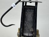 a small metal object with a black handle on it