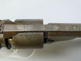 an old gun with a wooden handle on a white surface