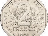 an image of a silver coin with the number 2 on it