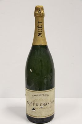 a close up of a bottle of champagne on a white surface