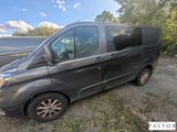 the grey van is parked on the side of the road