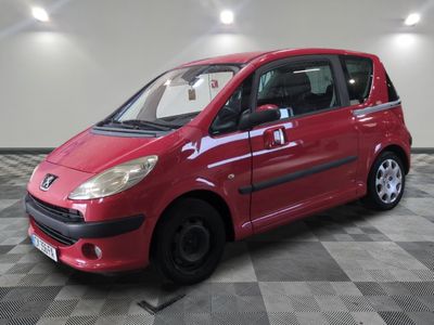 a picture of a small red car parked in a garage