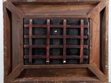 an old wooden box with a window on top of it