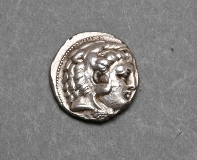 a close up of a silver coin with a woman ' s face on it