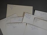 many papers with writing on them sitting on a table