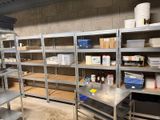 a room with a lot of shelves and a table in it