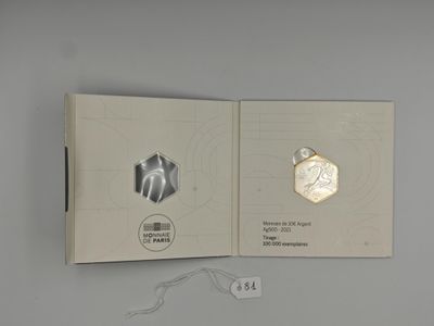 an open book with a picture of a hexagonal object on it