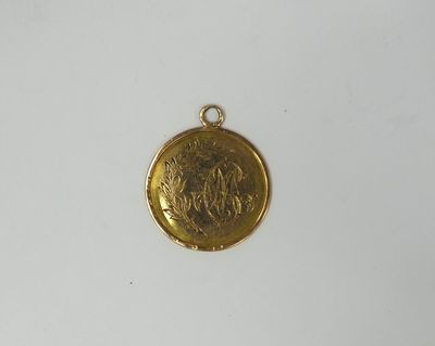 a close up of a gold coin on a white surface