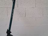 a scooter that is sitting against a wall