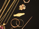 a lot of gold jewelry on a black surface