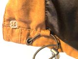 a close up of a brown and black jacket with a keychain