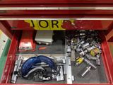 a red tool box with tools inside of it