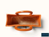 an orange purse with a handle on a white background