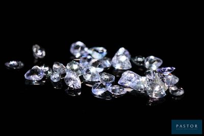 a close up of a bunch of diamonds on a black surface