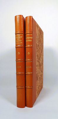 two books sitting on top of each other on a white surface
