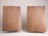 two pieces of wood with a metal stand on a white surface