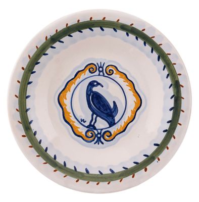 a plate with a blue bird on it on a white background