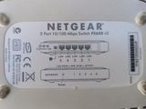 a white netgear router on a white table