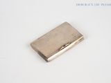 a small silver cigarette case sitting on a white surface