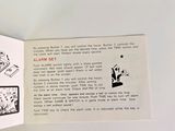 a hand holding an open book with a picture of a man on it