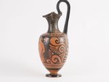 an old vase with a black and red design on it