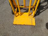 a close up of a yellow barricade on the ground